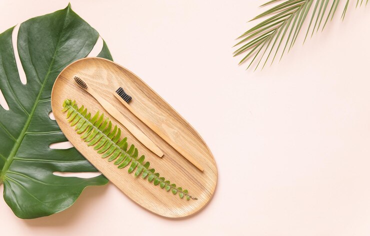 natural-toothbrush-wood-tropical-leaf-monstera-modern-pastel-background-zero-waste-plastic-free_1182-2562